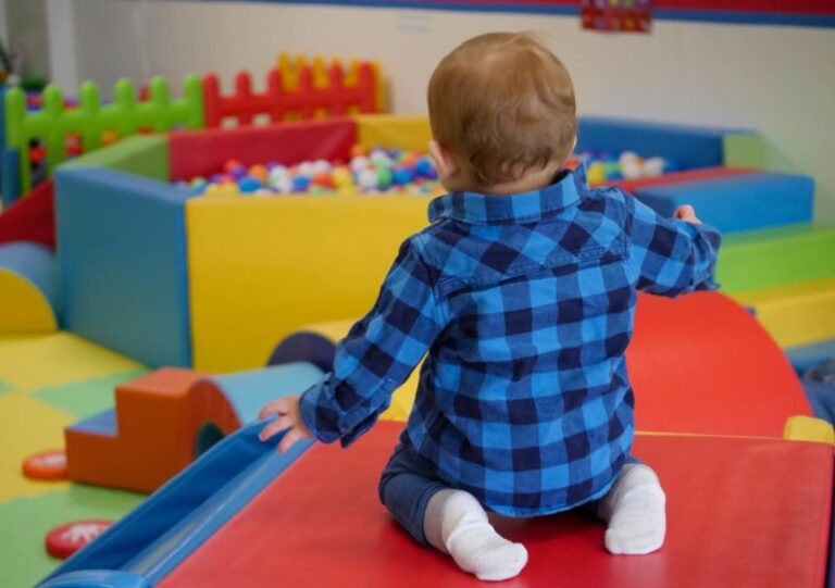toddler playing on indoor slide
